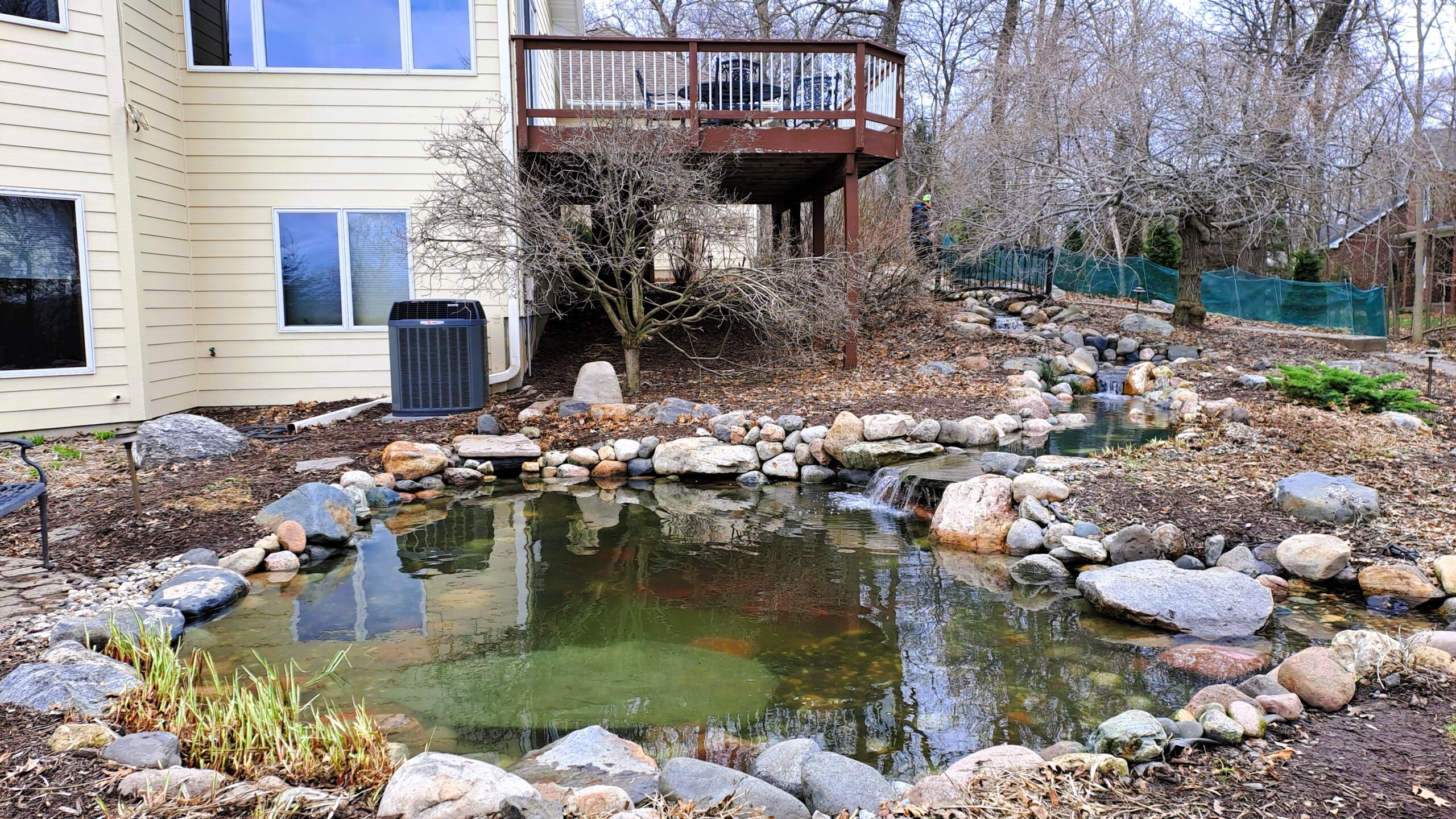 completed backyard pond upgrade with wetland filter, restored stream flow, and natural stone design in Minnesota