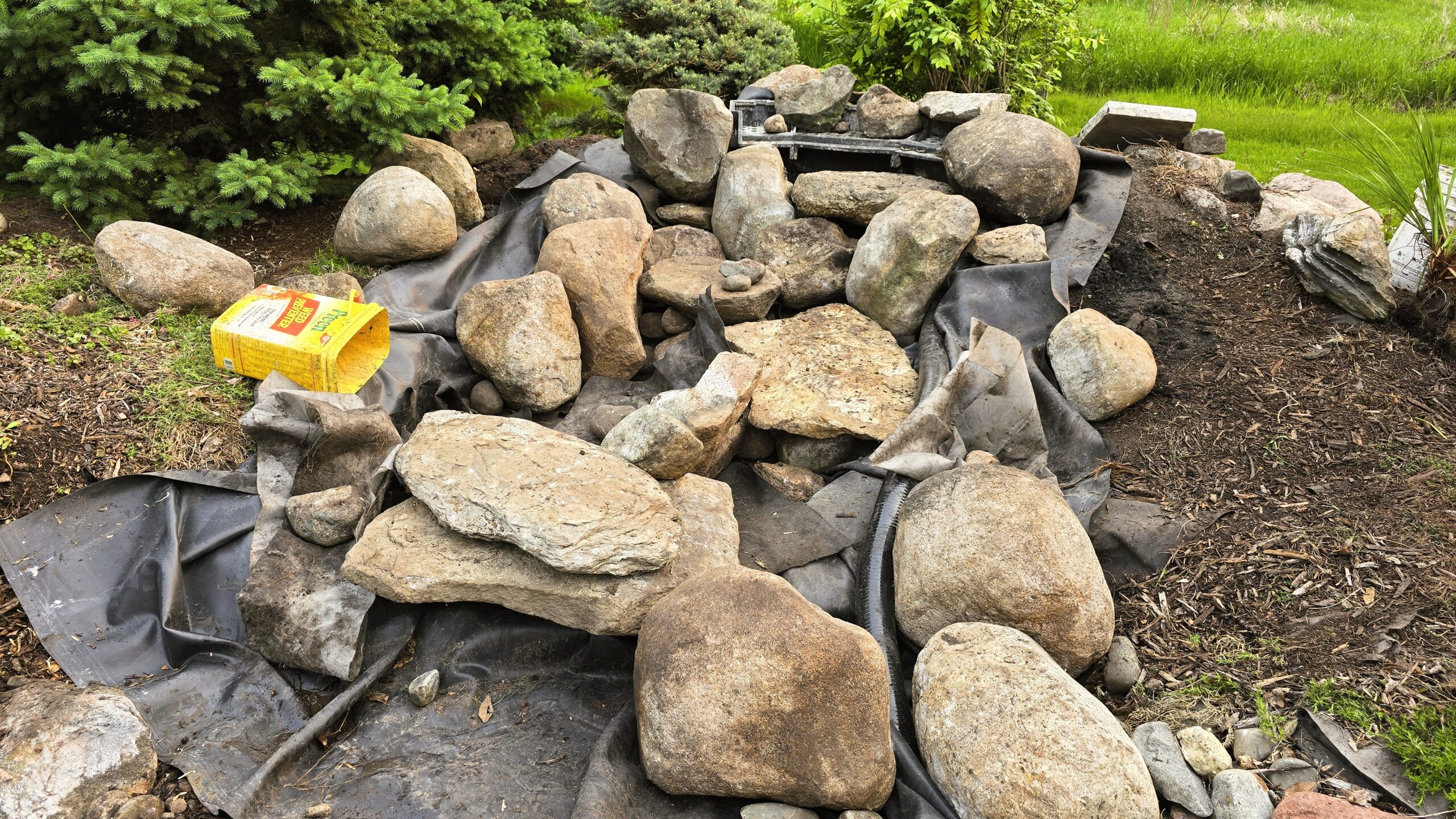 Complete removal of failing pond liner and old waterfall structure McAllister MN