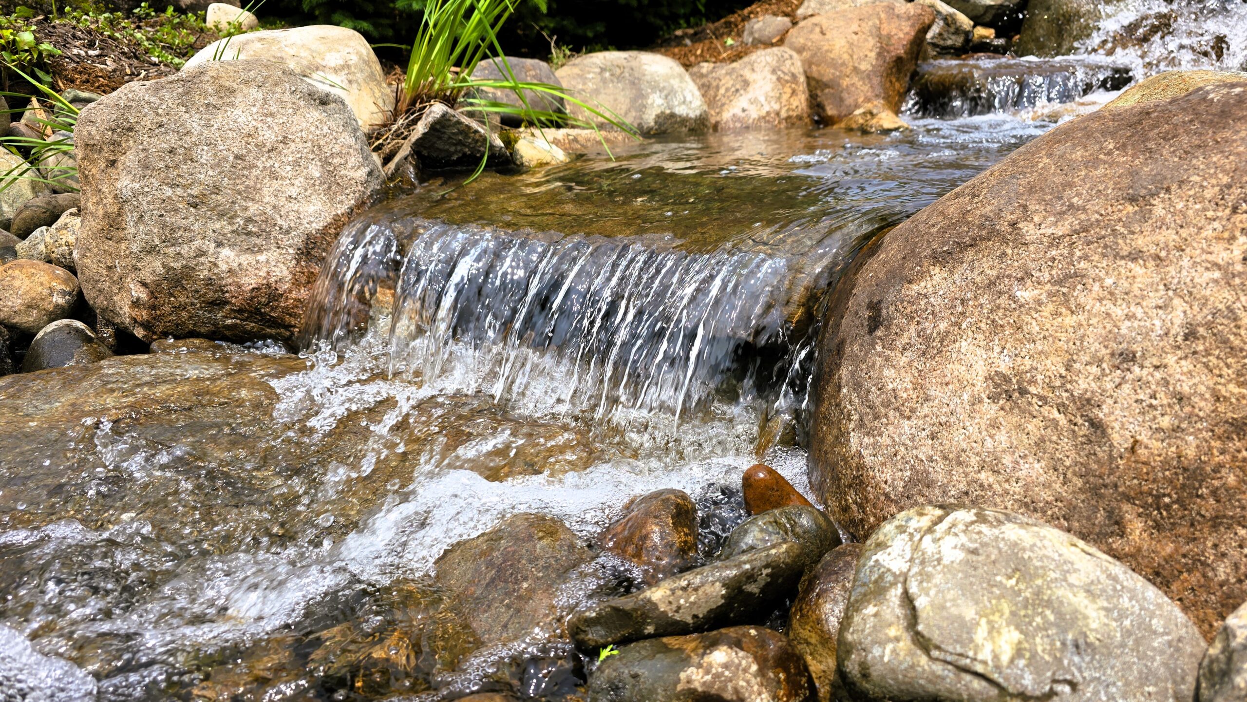 Natural rock waterfall cascading over boulders McAllister Minnesota reconstruction project