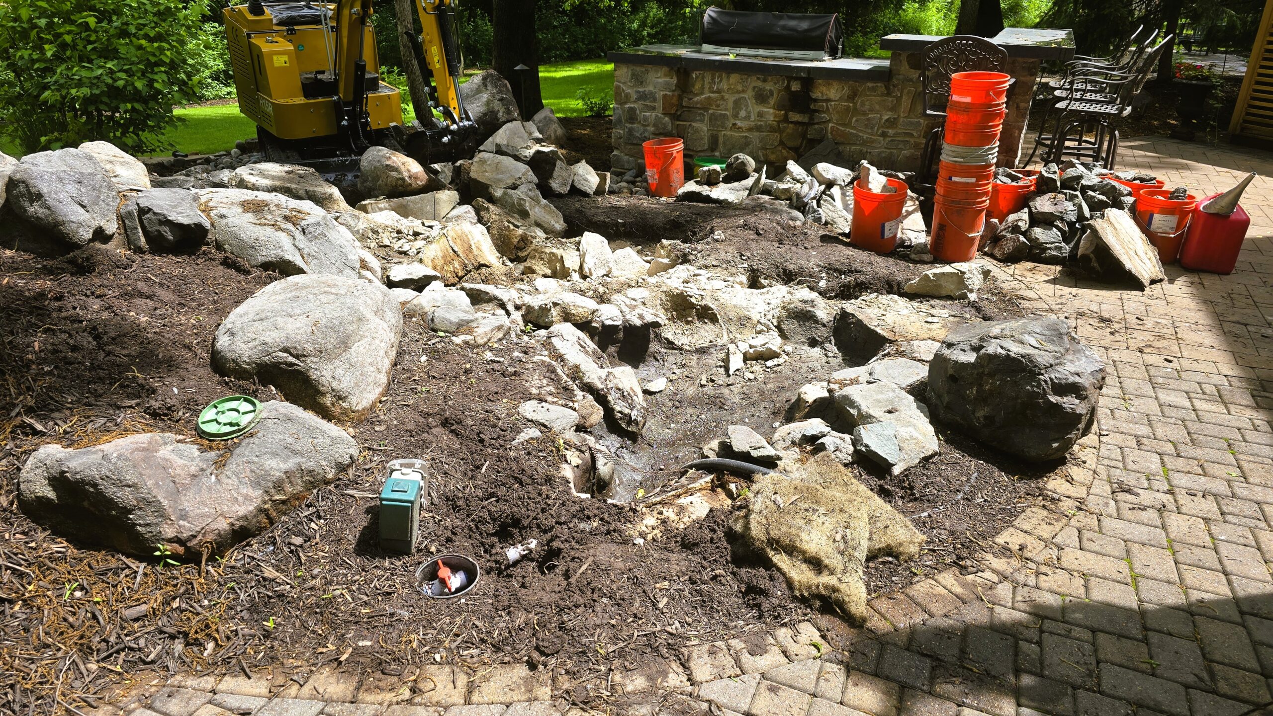 Granite boulder waterfall construction process in Eden Prairie, MN