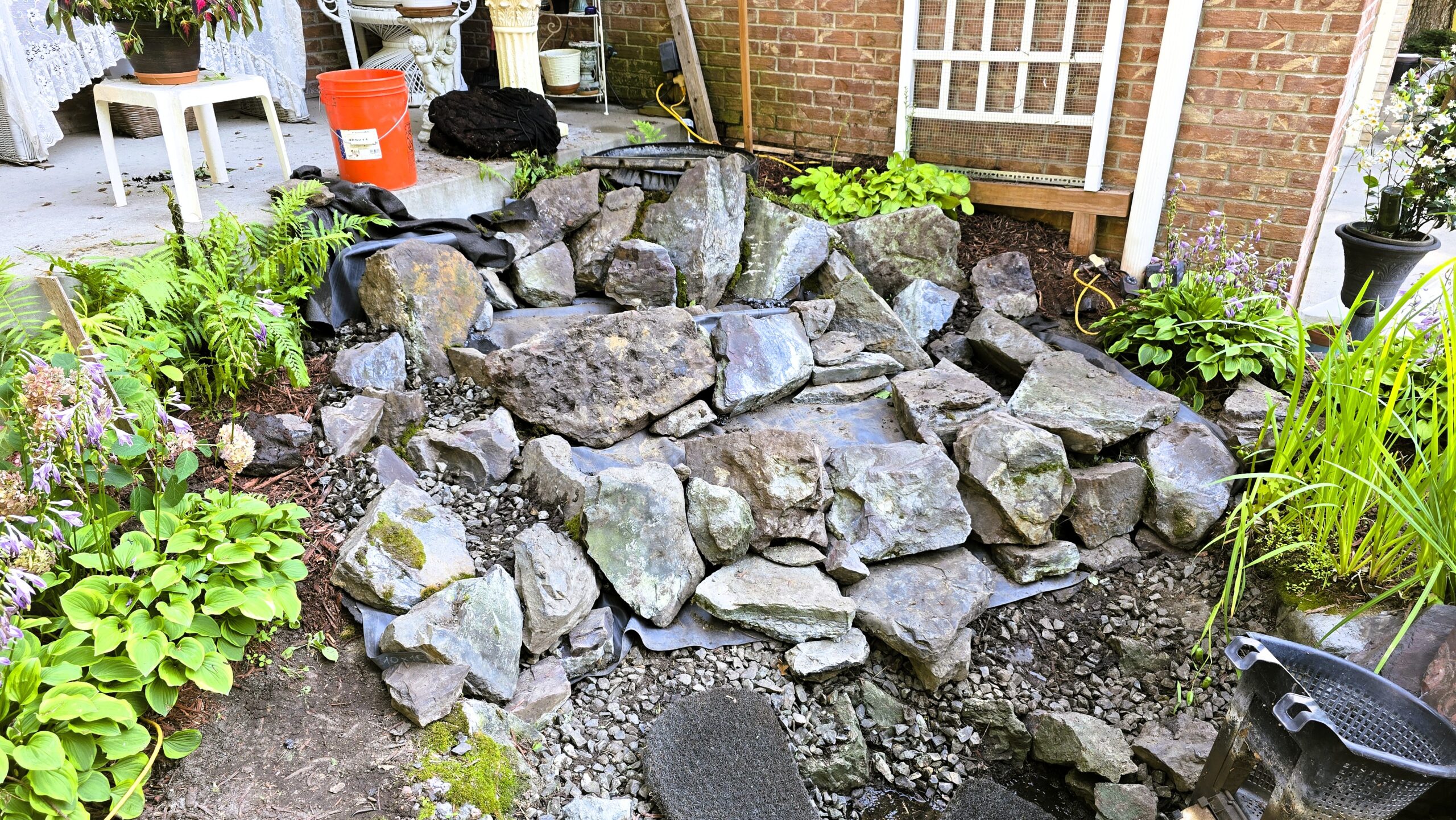 Stone placement and structure building for front yard waterfall rebuild in Blaine, Minnesota