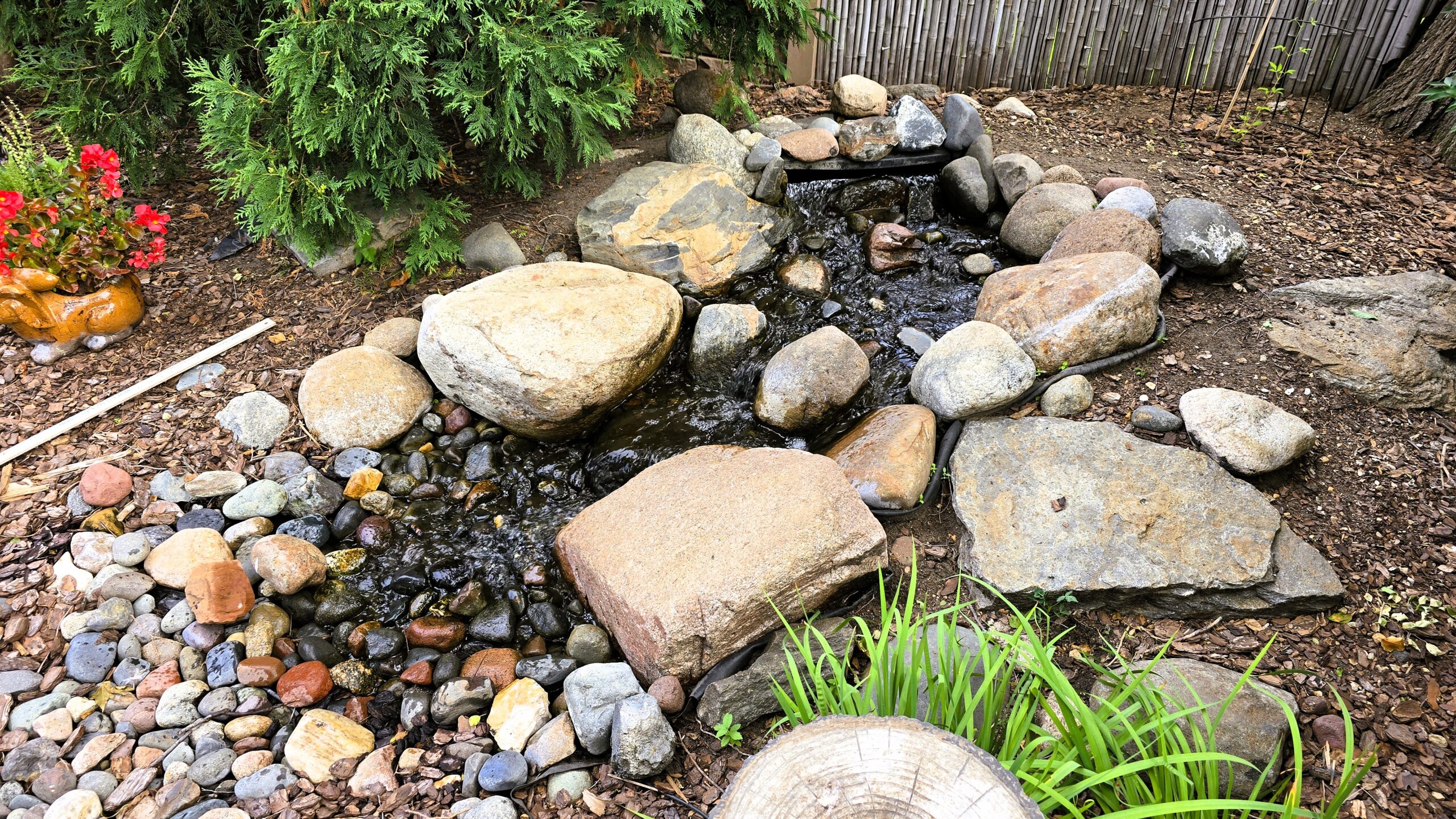 Leaking pondless waterfall with poor construction and liner issues in Hopkins Minnesota before rebuild