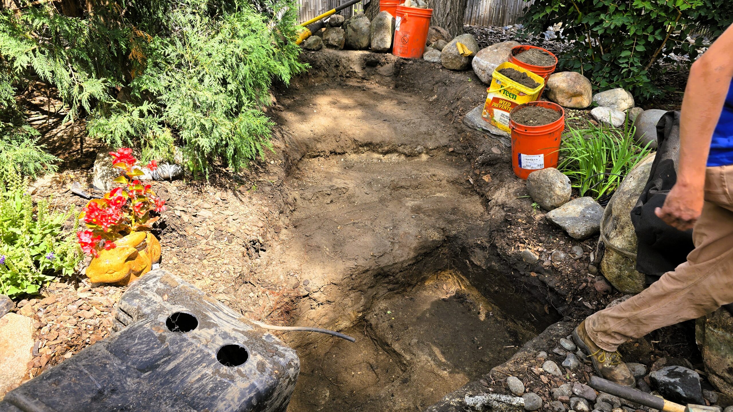 Pondless waterfall excavation showing removal of old liner and basin during rebuild in Hopkins Minnesota