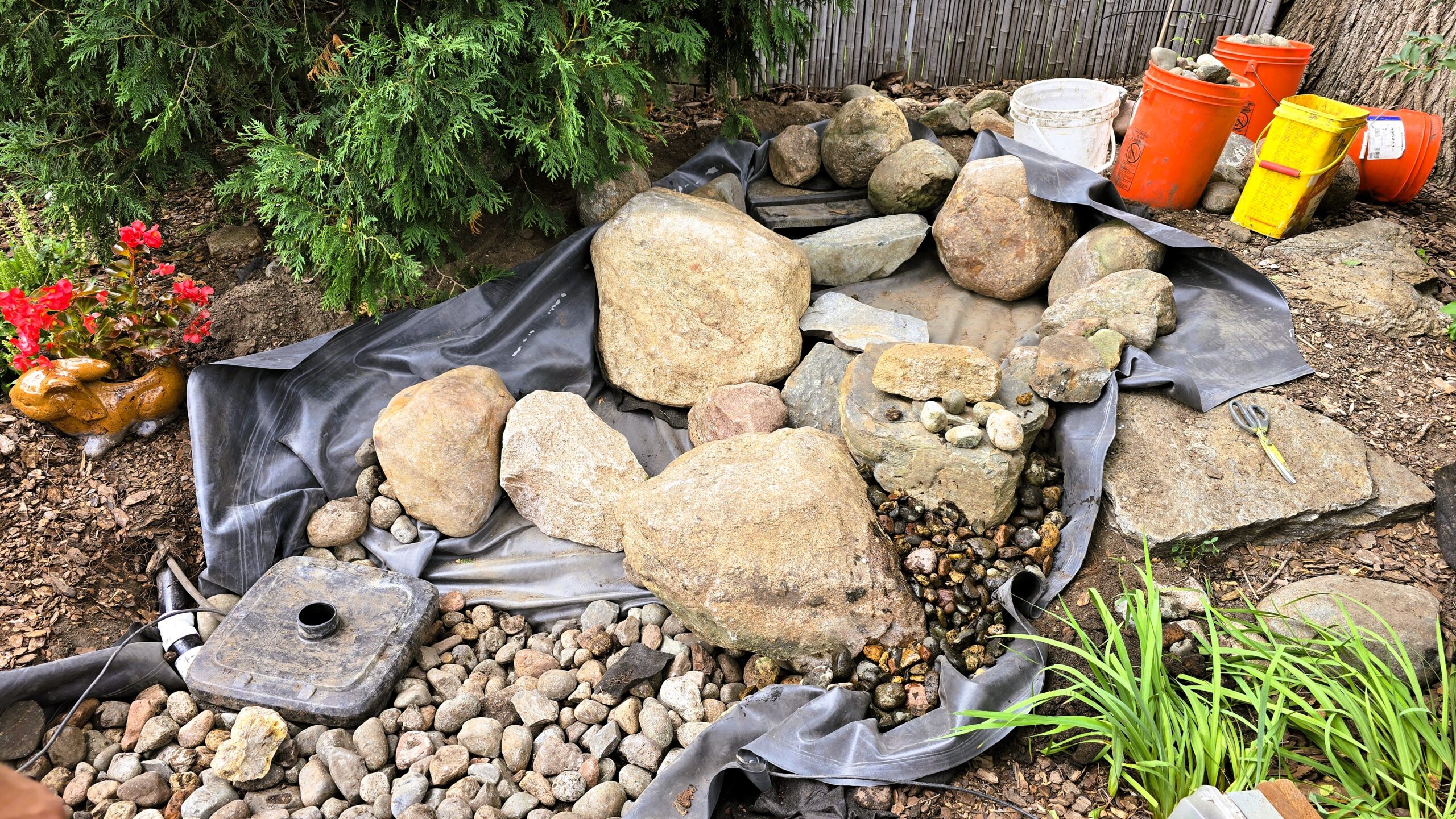 Rebuilding pondless waterfall with proper stone placement and drainage setup in Hopkins MN