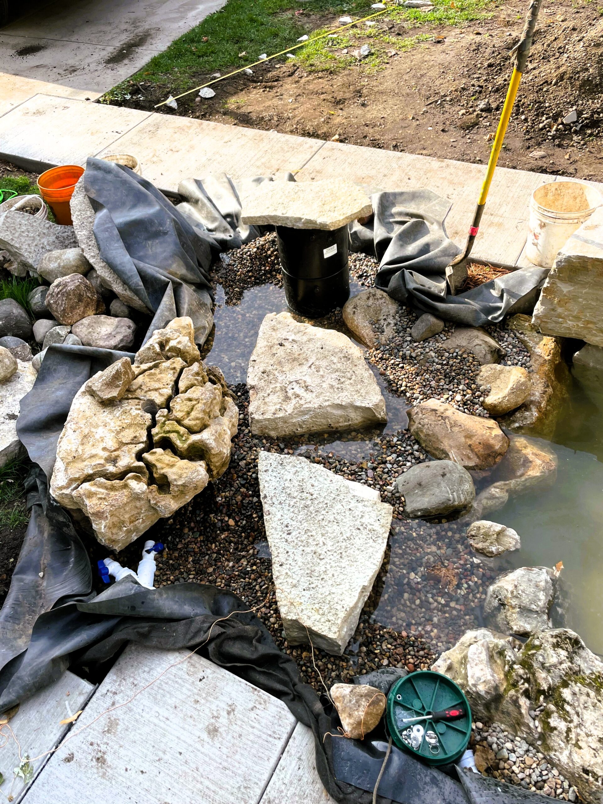 Wetland filtration system under construction with limestone stones and intake bay in Minneapolis, Minnesota