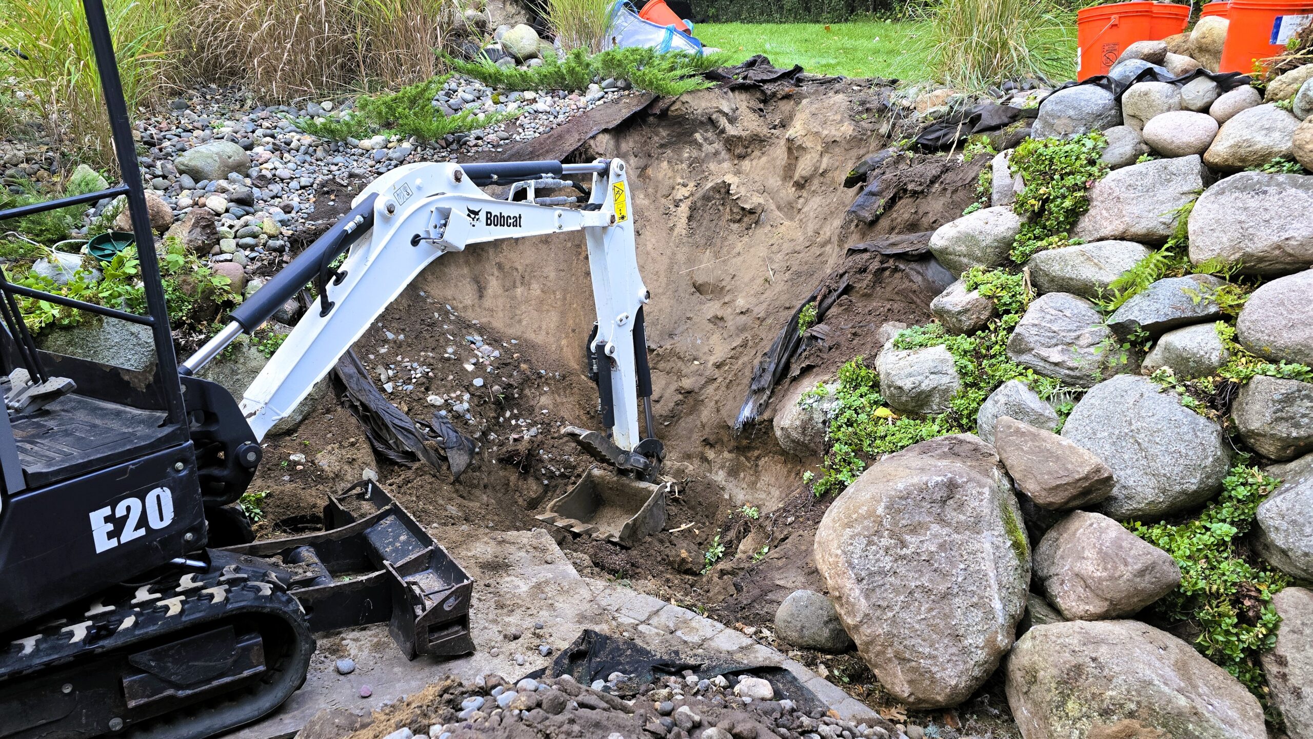 Excavation and reservoir construction for a pondless waterfall and wetland system in Ramsey, Minnesota