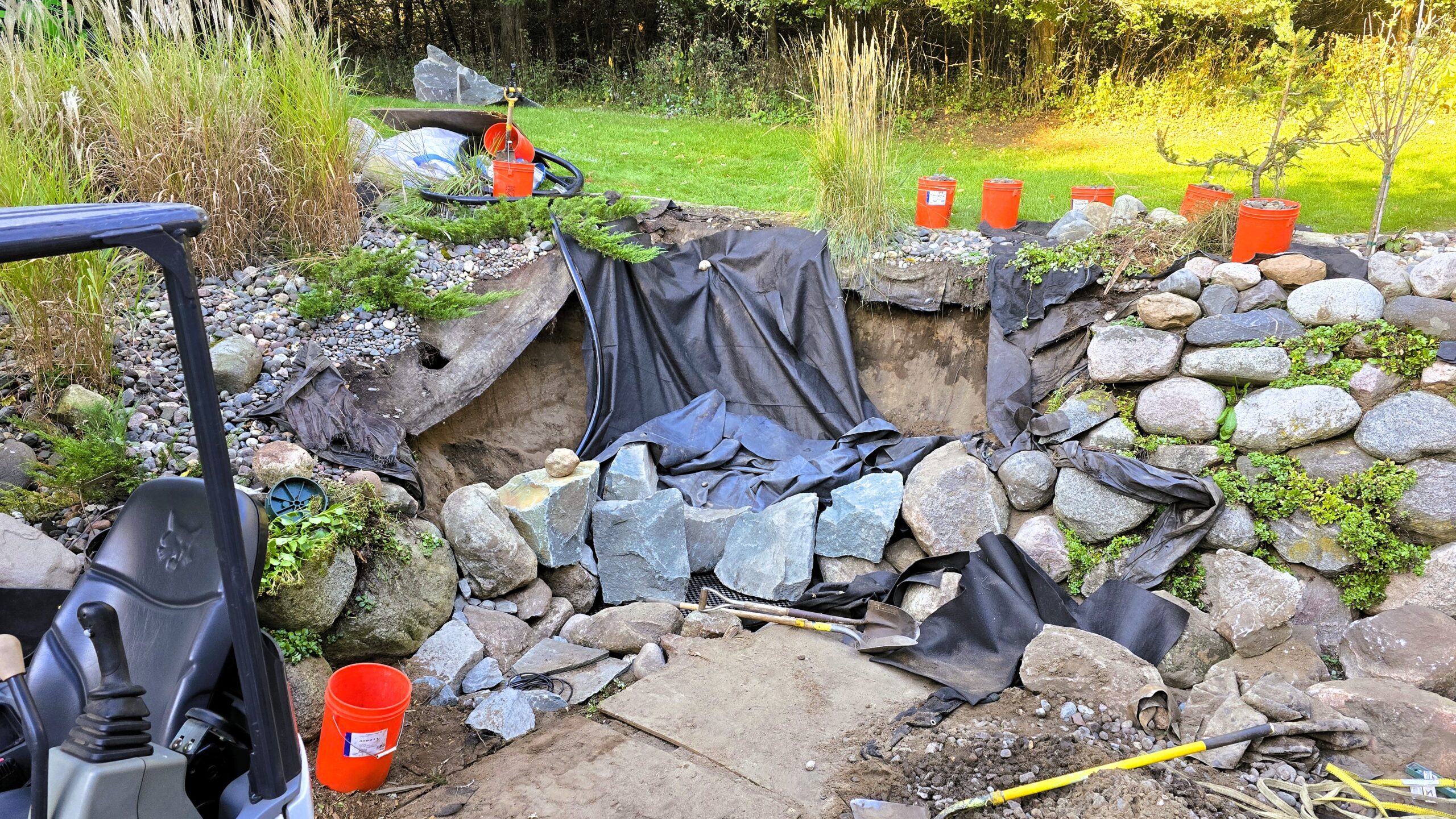 Reservoir excavation for a pondless waterfall system in challenging sandy soil conditions in Ramsey, Minnesota