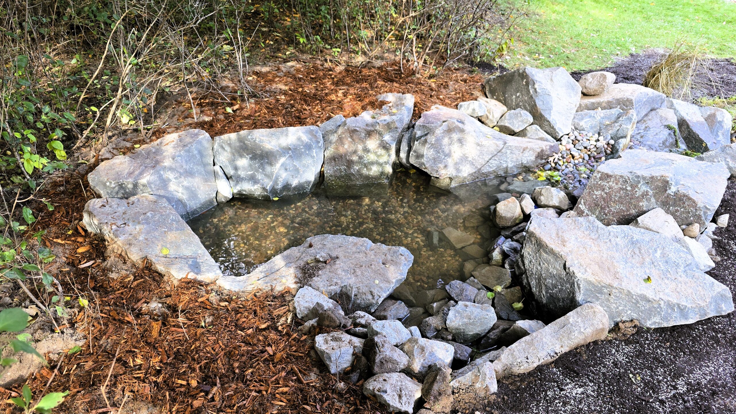 Integrated wetland filter supplying water to a pondless waterfall system in Ramsey, Minnesota